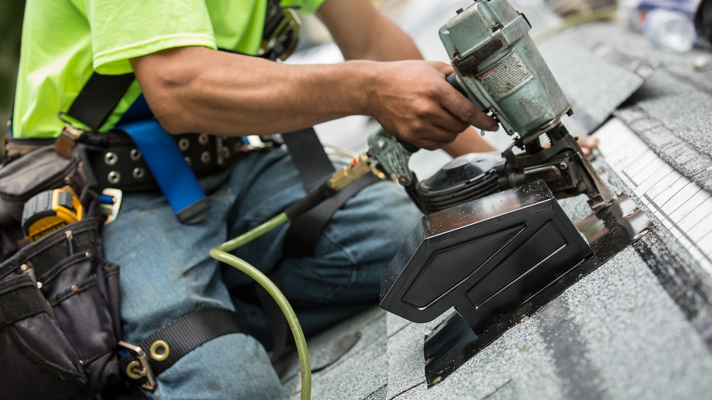 Asphalt shingles being installed on a home