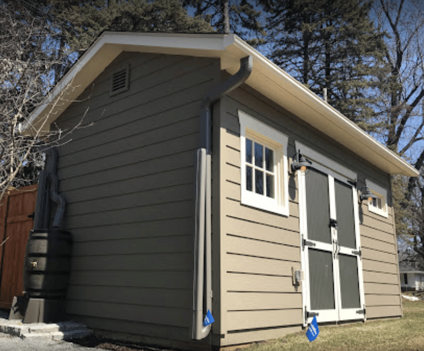 leaf guard gutter system with hinged downspouts on wisconsin shed