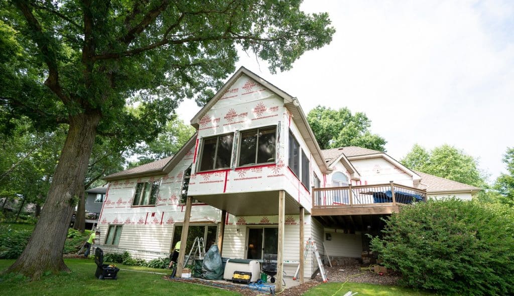 Siding installation with Insultex house wrap.
