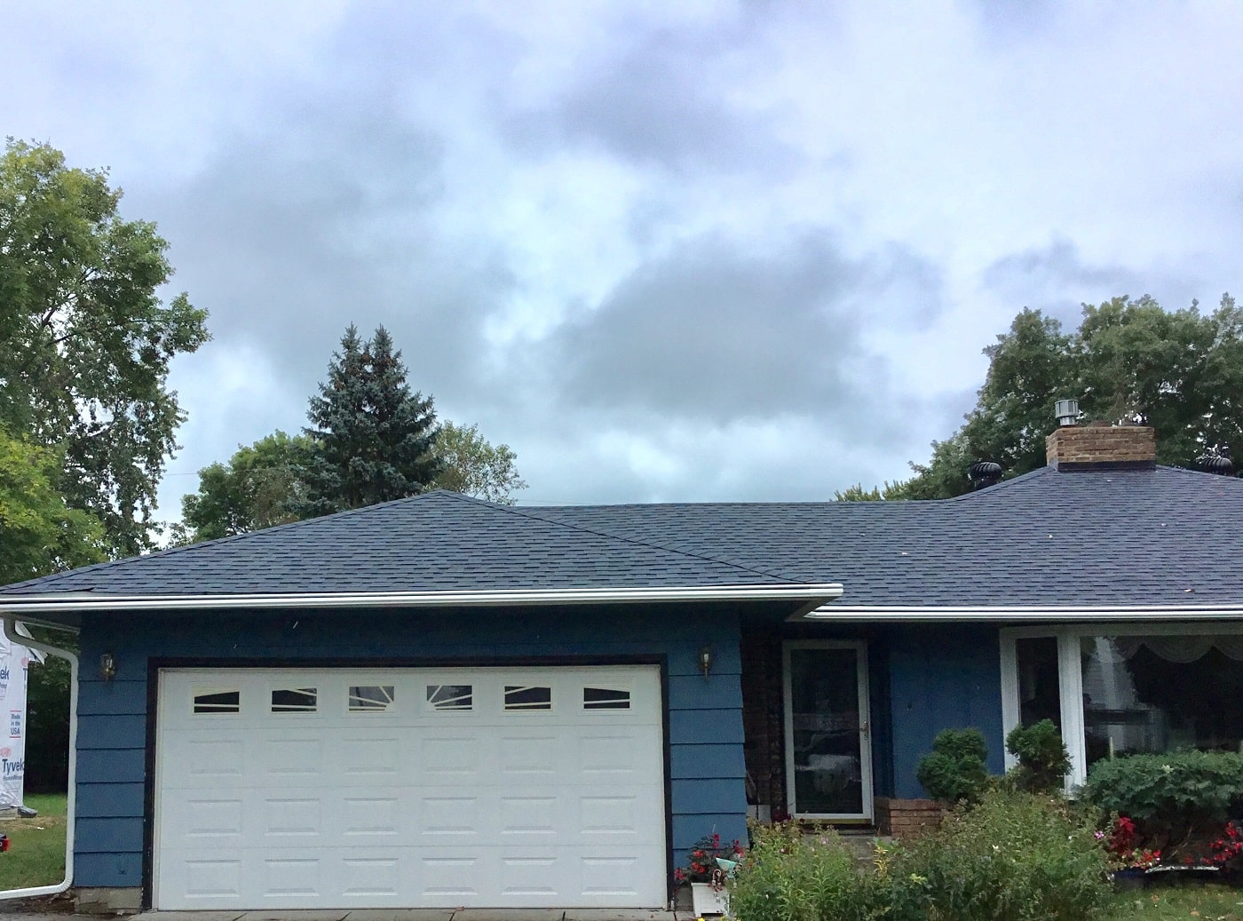 white LeafGuard brand gutters installed on Hopkins home