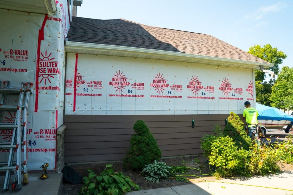 Siding installation using Insultex house wrap.