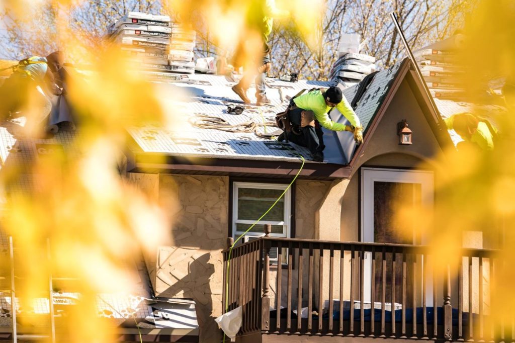 Roof installation by Lindus Construction on a home in the fall.