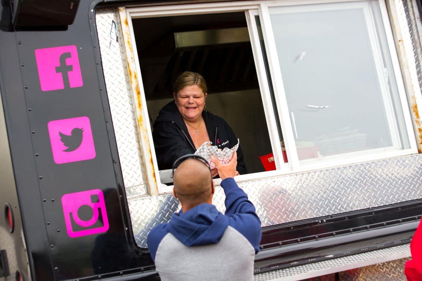 Food truck at our 40th anniversary serving food to a guest