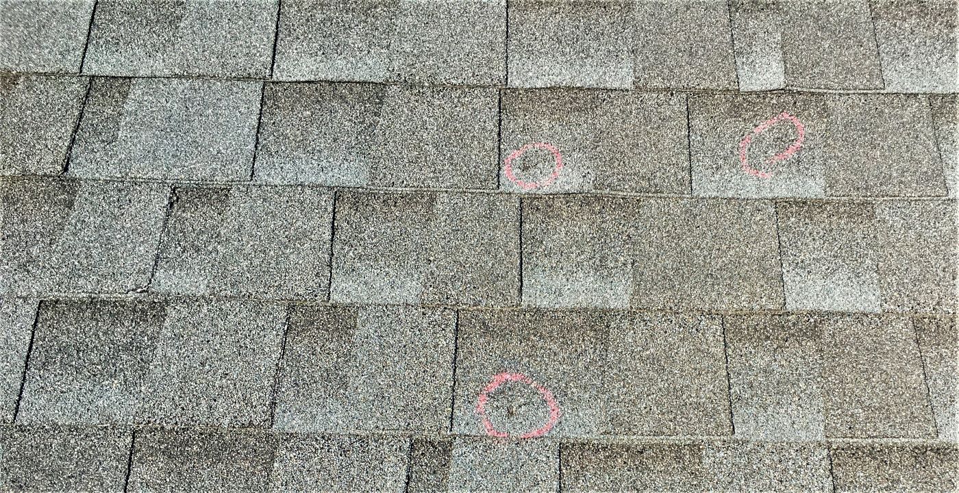 Asphalt shingles with hail damage